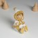 Souvenir Polystone "Baby in a white fur coat, with a heart" sits 5x5x8 cm