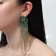 Hanging earrings with rhinestones "Magic" drops and waterfall, green color in gold, 14 cm