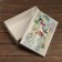 The box is folding, the lid is, "Happy New Year and Merry Christmas" 30 x 20 x 9 cm