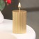 Candle-cylinder with faces, 5x7.5 cm, gold, 6 hours