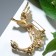 Brooch "Firebird with a magic tail", colored in gold