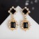 Earrings with rhinestones "openwork" duet, black color in gold