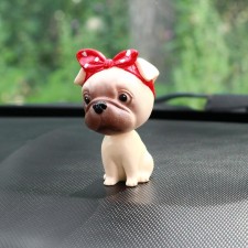 Dog on a car panel shocking his head, pug