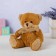 Soft toy "Bear", in a knitted scarf, mix color