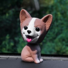 Dog on a car panel shocking his head, jusk, brown