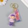 A keychain plastic, rubber with a carbine, a "girl in pink" 3x4.2x7 cm strap
