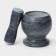 A mortar with an “marble” push, made of natural stone
