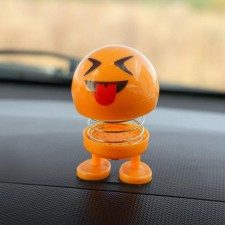 Smile on the spring, on the panel in the car, tongue, yellow