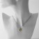 Piece "heart" with a rhinestone, white-yellow color in silver, 42 cm