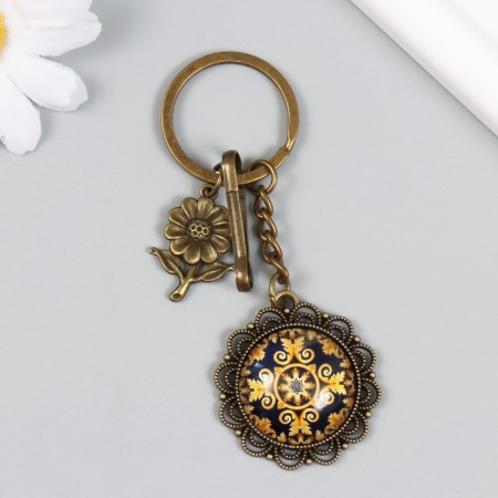 A metal keychain, glass with a carbine "Flower and patterns in the medallion" Bronze 9.5 cm-1