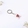 Key keychain “Our love is...”, acrylic, 13.3 x 8
