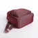A backpack with a zipper, 5 outer pockets, pencil case, burgundy color