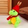 Soft toy "Dragon", in a red hat with ears, 15 cm, green color
