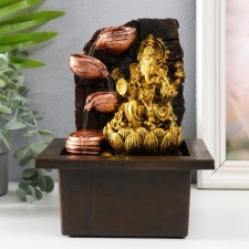 The desktop fountain from the Golden Ganesh network in the lotus near the stone wall 