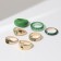 A set of rings 7 pieces Amour, green color in gold, 16-18 dimensions