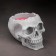 Figure Aromatic candle in concrete "Skull", 14x11 cm, red, garden berries