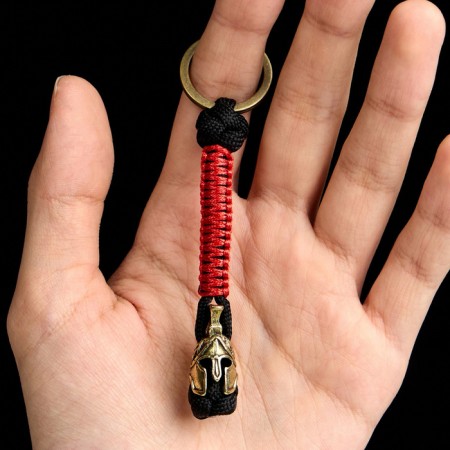 A keychain - a launcher for a spartan knife from a paracord, black -red, bead - bronze