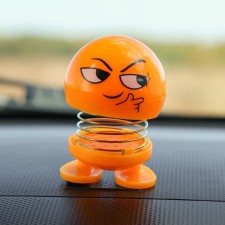 Smile on the spring, on the panel in the car, cunning, yellow