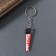 Acryl key a mirror "bloodied saw" 5.1x1.3x0.3 cm