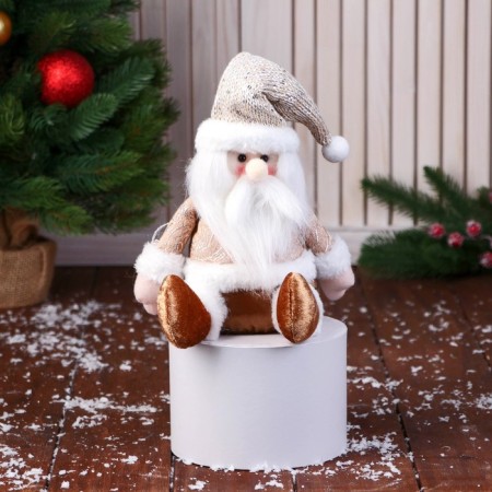 Soft toy "Santa Claus in a knitted cap" sits, 15x22 cm, golden brown
