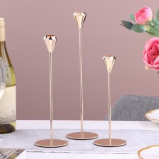 A set of 3 candlesticks, metal, h = 31.5/26.5/21.5 cm