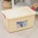 Storage container with a lid 50 l, 59 × 39 × 32 cm, on wheels, ivory color