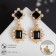 Earrings with rhinestones "openwork" duet, black color in gold