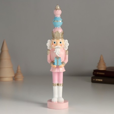 Polystone souvenir "Nutcracker in a pink uniform, with a gift" 4.5x4.5x21 cm