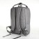 A backpack of textiles on a zipper, 3 pockets, a laptop, color gray