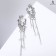 Hanging earrings with rhinestones "Firebird" with drops on a chain, white color in silver, 7 cm