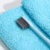 The toothbrush is soft, in the tube, turquoise