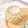 Candle "Shar" in the candlestick with convex spherical faces of gypsum, 8x7 cm, gold