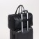 Road bag with a zipper, a suitcase holder, a long belt, black color