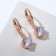 Earrings with bloom rhinestones hanging, white color in gold