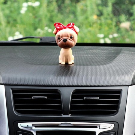 Dog on a car panel shocking his head, pug-2