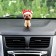 Dog on a car panel shocking his head, pug