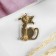 Brooch "Cat" shy, black color in gold