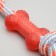 A training cable toy with a bone, up to 120 g, up to 40 cm, mix of flowers