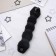 A roller with a mount and an elastic band for creating a bundle, 5x22.5 cm, black