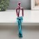 Souvenir Polystone "Consuming Man" pink-blue 5x8.5x21 cm
