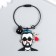 Acryl keychain on a cable with a bell "Bearded guy with glasses and rose"