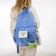 A backpack with a zipper, 4 external pockets, the color is light blue