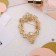 Brooch "Halu", white color in gold