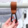 Carabiner for bags for a stroller, for Velcro, eco -leather, brown color