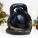 The piggy bank "Snake with weights" is black, 25 cm