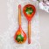 A spoon of wooden "rubella", a half -bacon, a red background