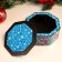 The box is octagonal, blue, mix, 15.3x15.3x6.7 cm