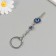 Keychain from the evil eye metal "Key of luck" 2x7 cm