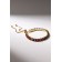 Bracelet with rhinestones "shine" on a puff, colored in gold