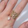 Ring "crumpled lines" with bead, white color in gold, dimensionless